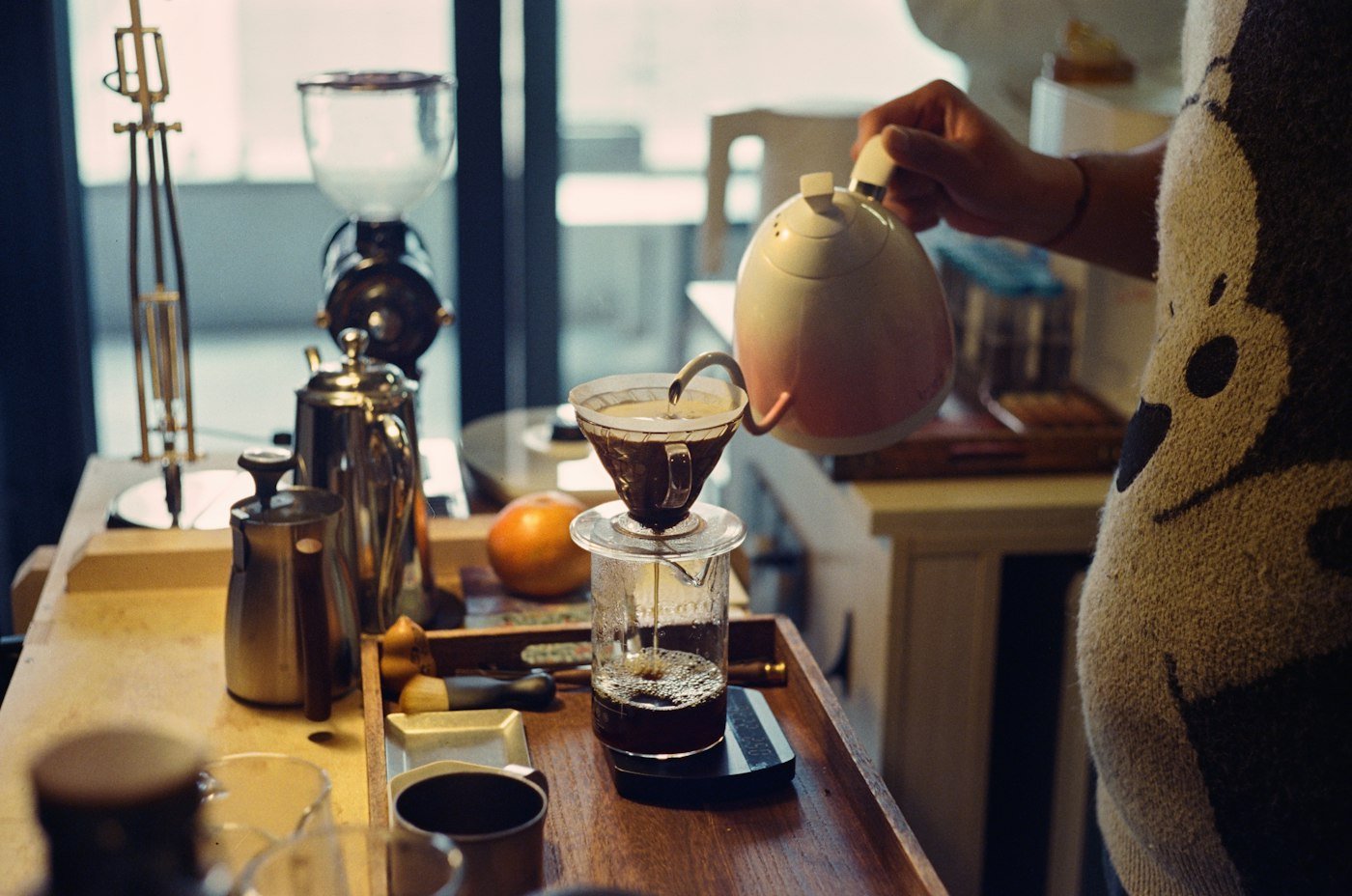 Woman pouring coffee in a kitchen